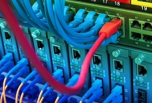 Network engineers installing fiber optics